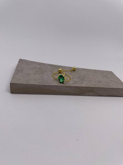 Thin gold chain adjustable ring with green oval gem and small gold sphere adjuster