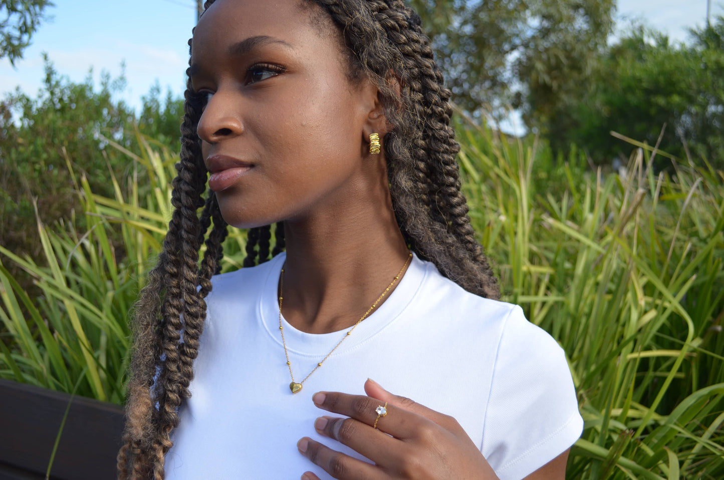 Abstract gold hoop earrings worn on a girl with The Afsanas Heart Necklace and The Faridas Adjustable Ring