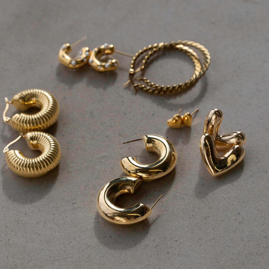 Group shot of various pairs of Shokhi Jewellery gold earrings